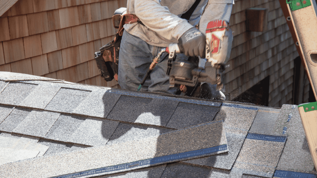 nailing asphalt shingles on roof