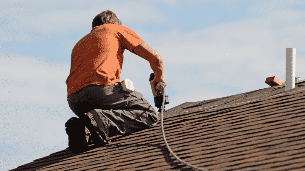 roofer installing asphalt shingles