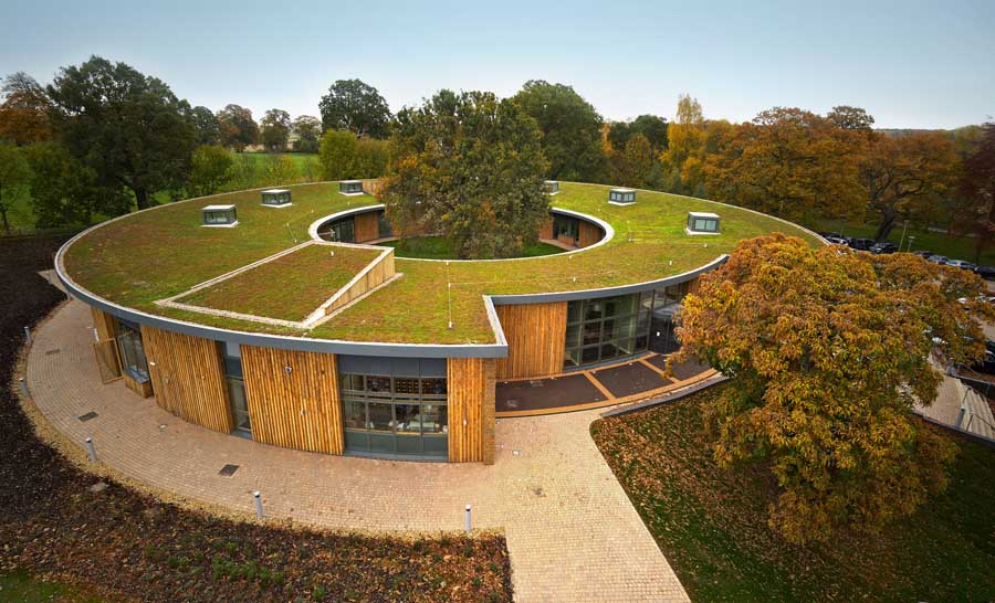 A donut-shaped building with a planted green roof