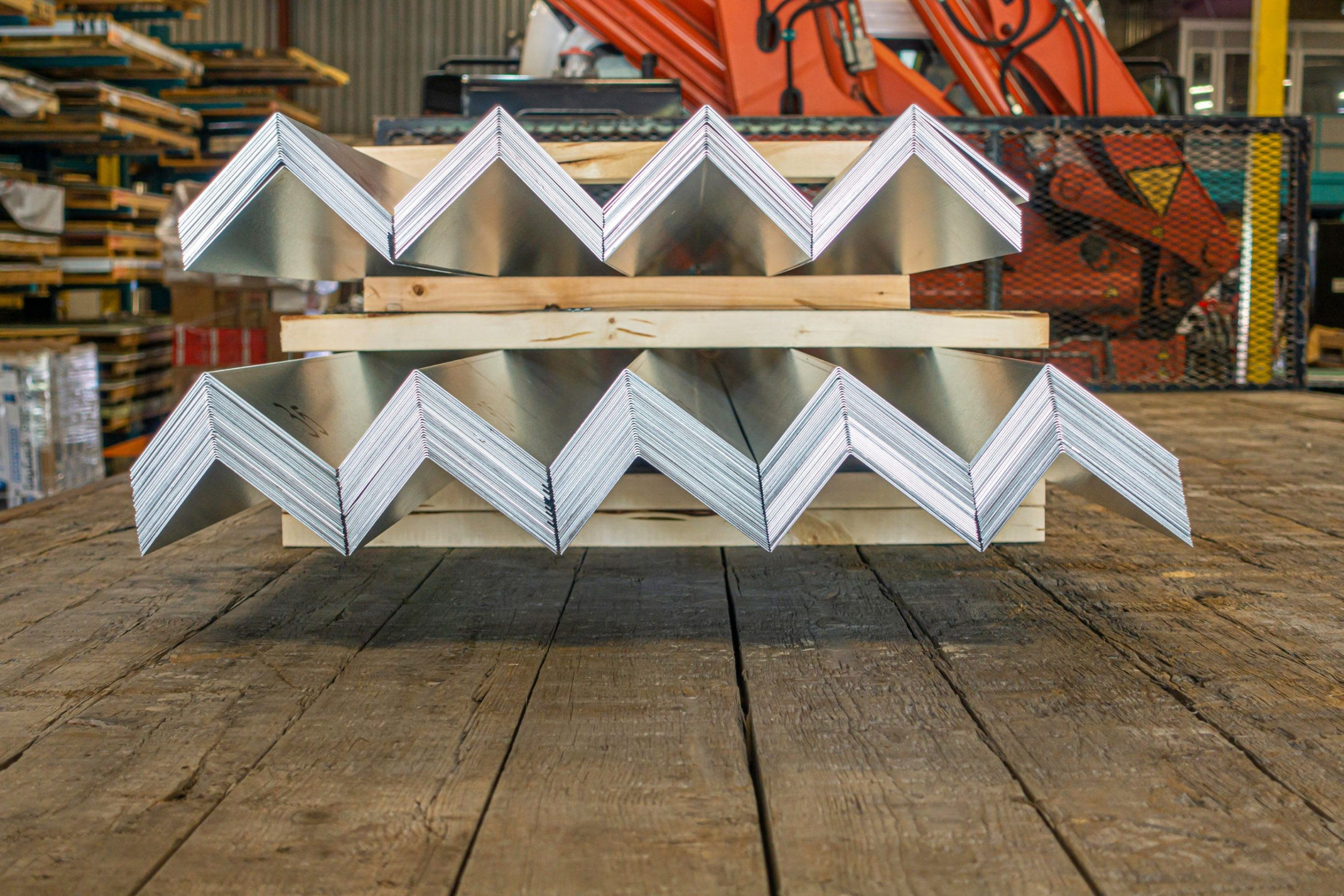 Newly-fabricated roof flashing stacked in a factory